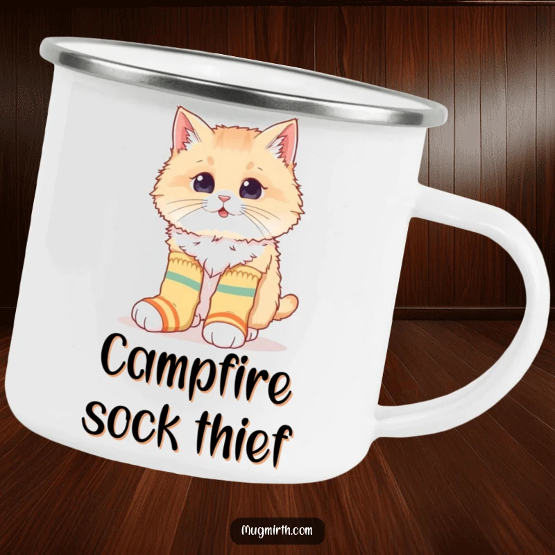 Funny camping mug with a fluffy cat hilariously attempting to wear mismatched socks, perfect for enjoying quirky adventures outdoors.